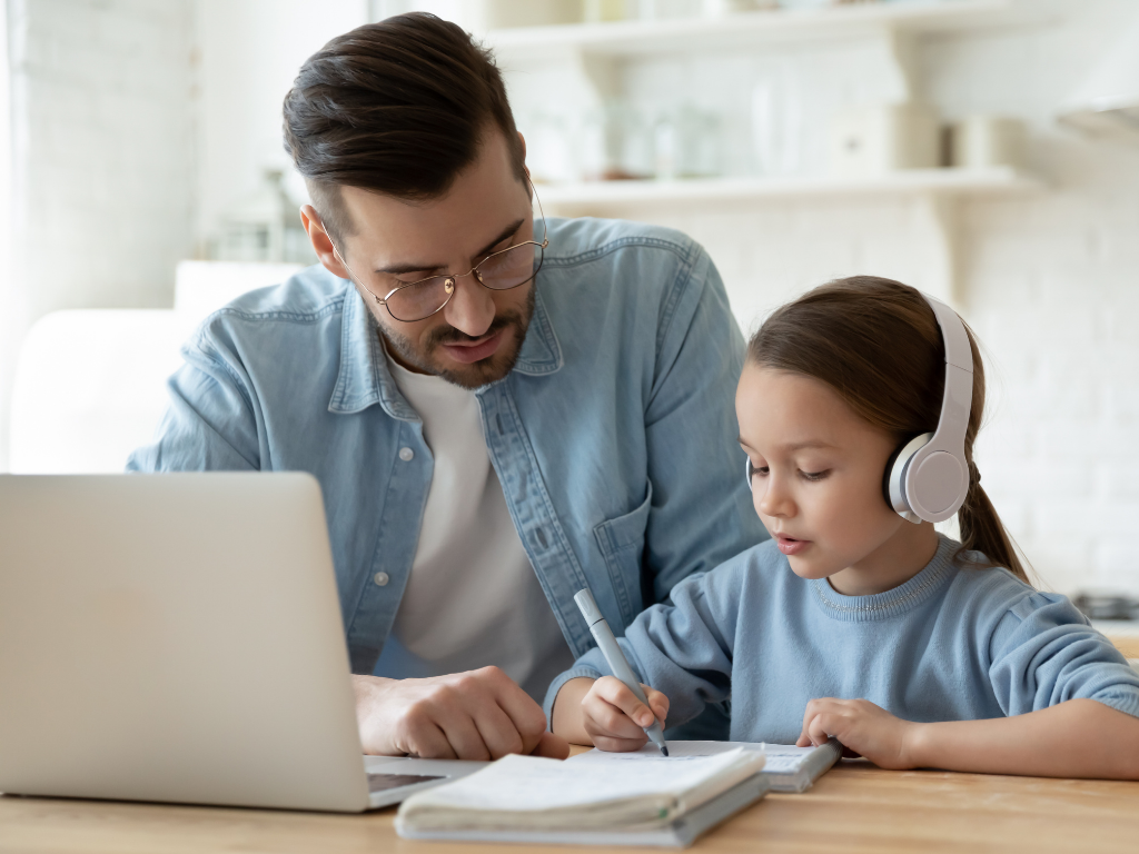 Father helping daughter with online learning